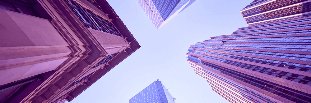 View of skyscrapers from the ground, converging in the sky at a central point