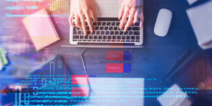 Typing on a laptop with data graphic overlays, blog article discussing CINTAP Cloud onboarding features